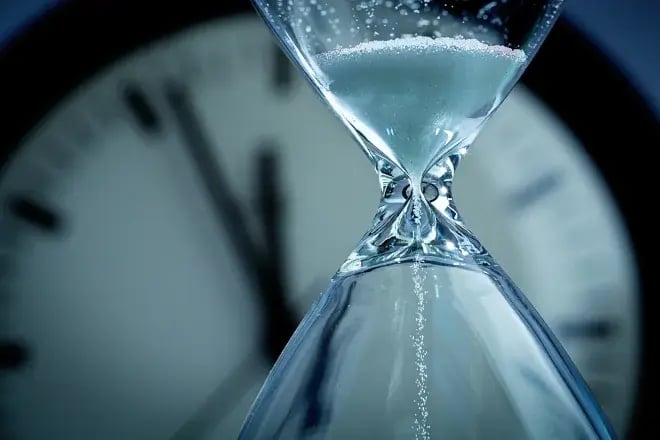 hourglass in front of glass